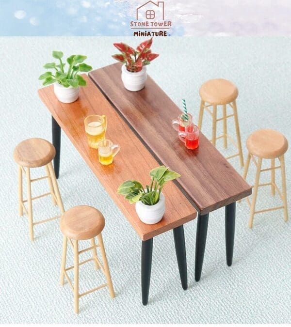 Miniature wooden tables with plants and drinks, surrounded by small wooden stools on a light blue carpet.