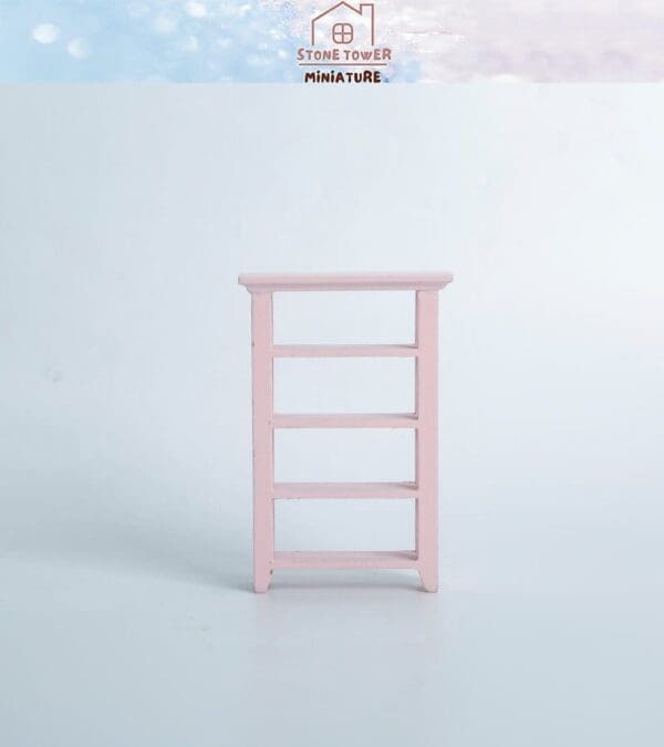 Pink miniature ladder with four rungs against a light blue background, labeled "Stone Tower Miniature.