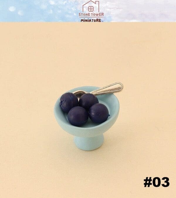 Miniature blue plate with blueberries and a tiny spoon, labeled #03 from Stone Tower Miniature.