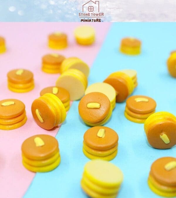 Miniature pancake stacks with butter on pastel backgrounds, by Stone Tower Miniature.