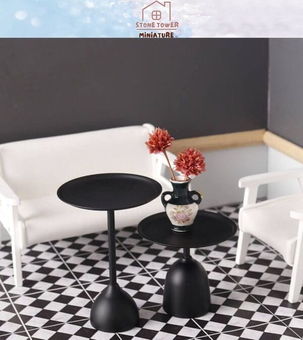 Miniature modern living room set with black tables, a floral vase, and white chairs on a black-and-white checkered floor.