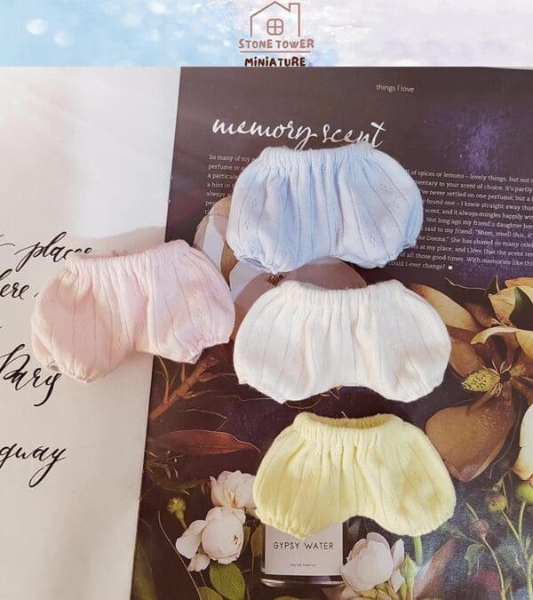 Four pastel-colored miniature bloomers on a magazine page with floral images and text.