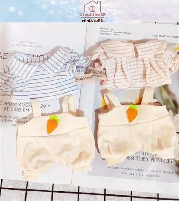 Striped shirts and carrot-themed suspenders for dolls displayed on open magazine pages.