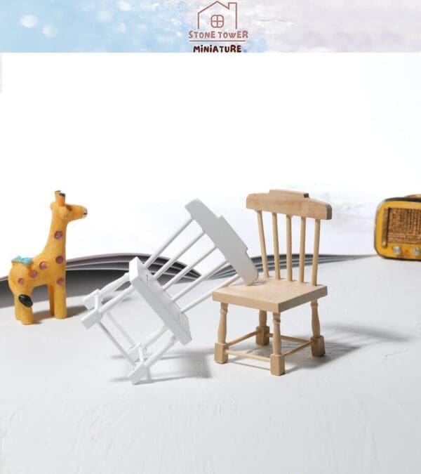 Miniature wooden scene with chairs, a giraffe figurine, and a tiny radio, on a white surface with a soft background.