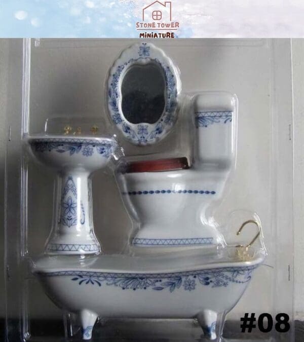 Miniature bathroom set with blue floral designs, including a bathtub, toilet, sink, and mirror in packaging.