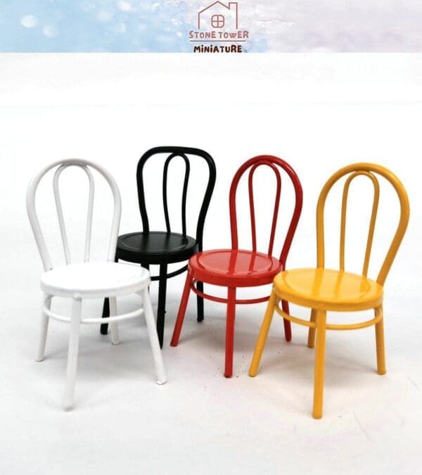 Four miniature chairs in white, black, red, and yellow on a white background.