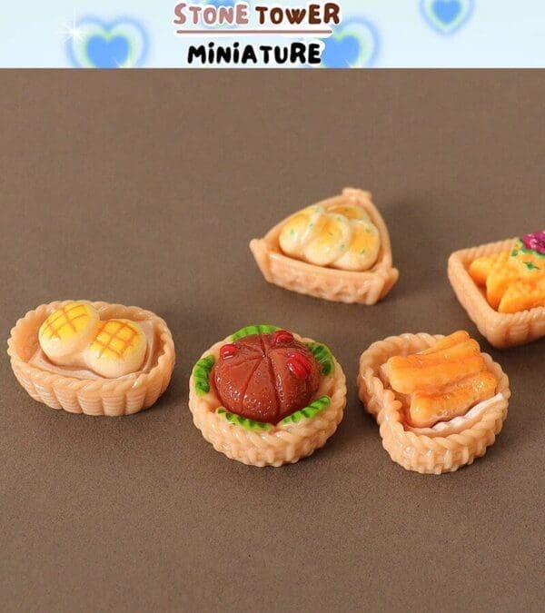 Miniature food baskets with assorted designs on a brown surface, labeled "Stone Tower Miniature.