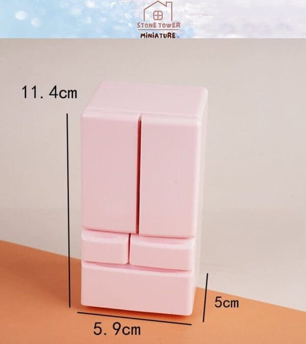 Pink miniature fridge model with dimensions labeled as 11.4cm, 5.9cm, and 5cm, set against a light background.