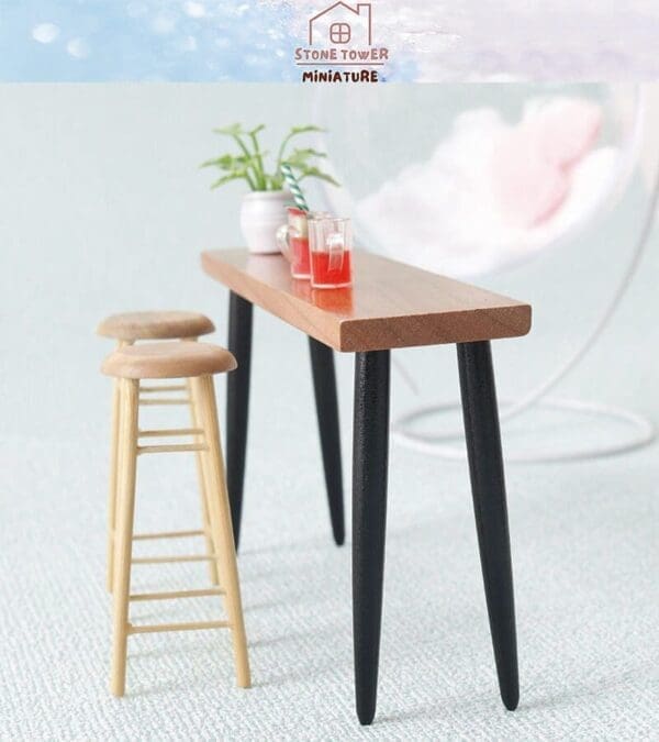 Miniature bar table with two stools, drinks, and a plant, set against a soft background.