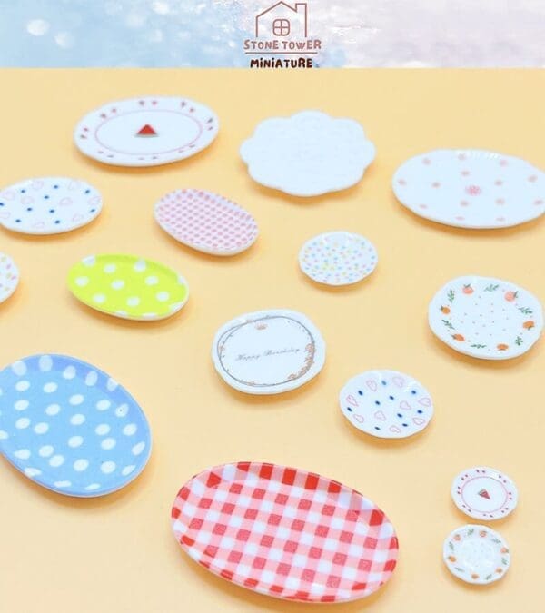 Colorful miniature ceramic plates with various patterns on a peach background.