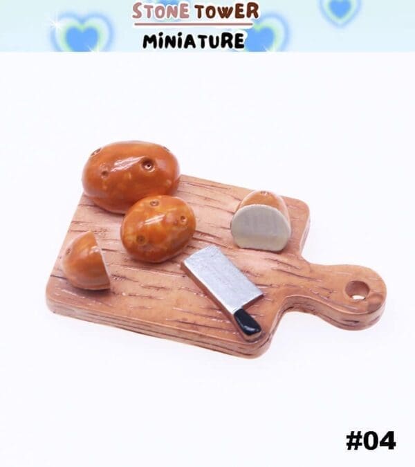 Miniature potatoes and knife on a wooden chopping board.