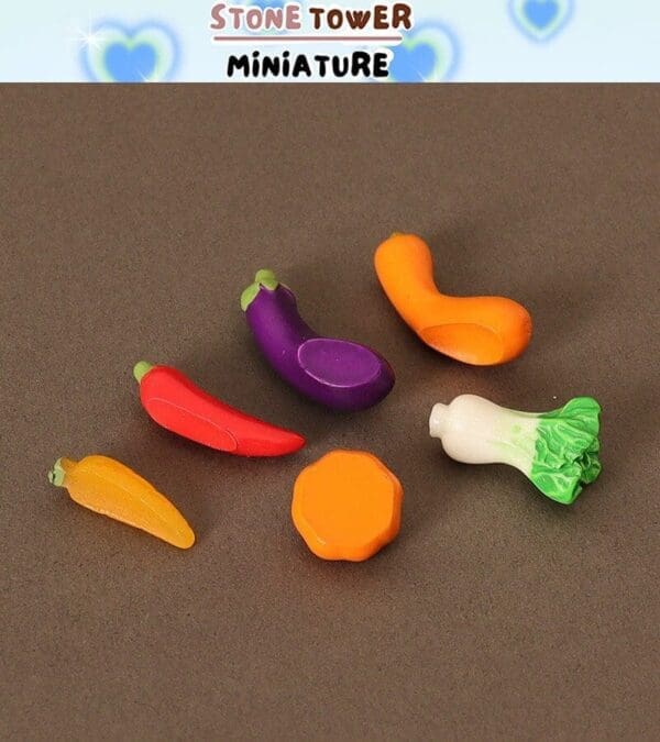 Miniature plastic vegetables on a brown surface, including carrot, eggplant, chili pepper, and bok choy.