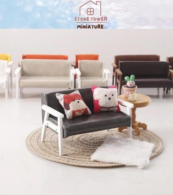 Miniature black sofa with animal pillows on a round mat, next to a small table with a potted plant.