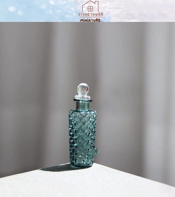 Blue glass perfume bottle with textured pattern and round stopper on a light surface.