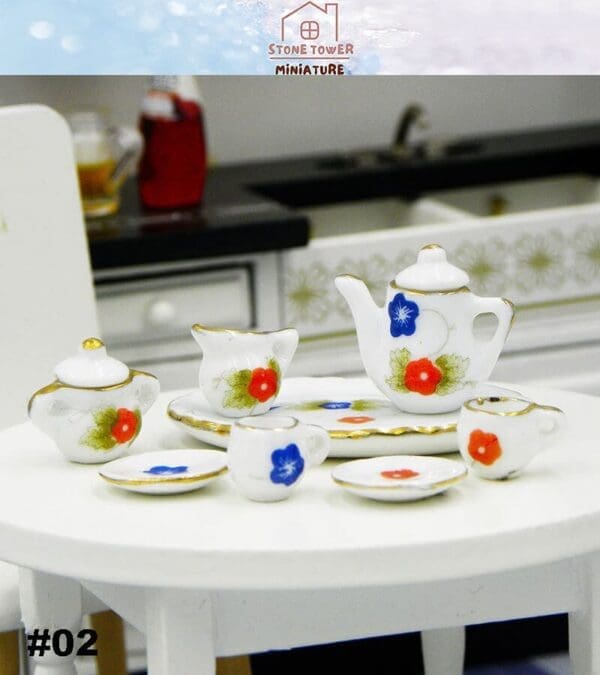 Miniature tea set with floral design on a white table in a kitchen setting.