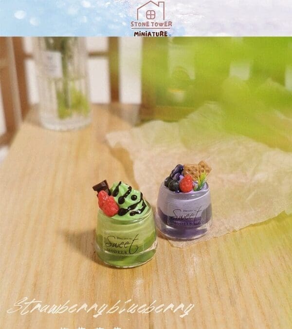 Miniature desserts with green and purple frosting, topped with berries, on a wooden surface.