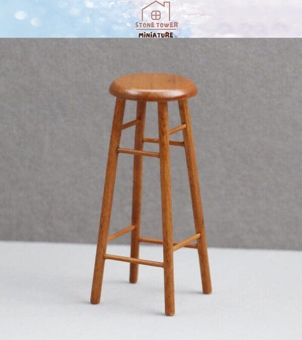 Wooden miniature bar stool with four legs and a round seat on a neutral background.