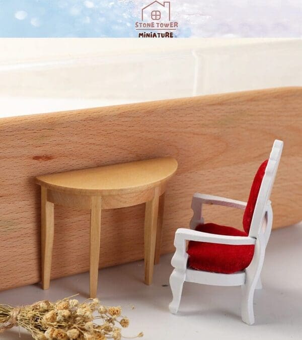 Miniature wooden table and red velvet chair against a wooden backdrop with embroidered text above.