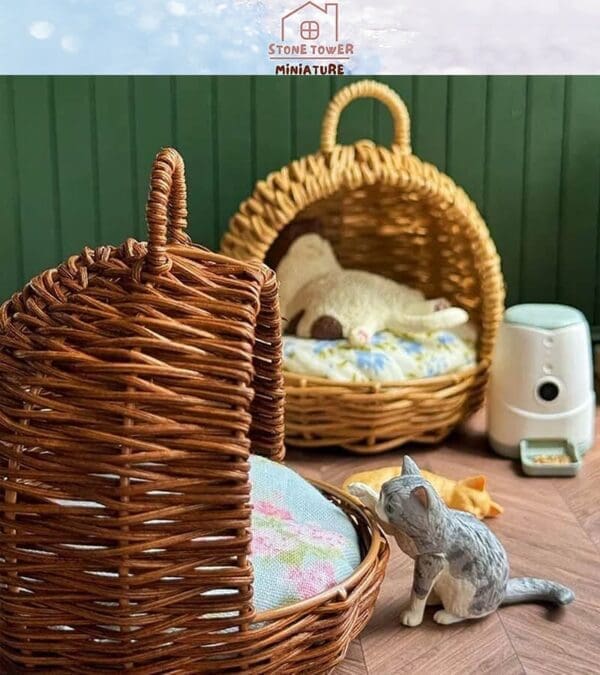 Miniature wicker pet baskets with a toy cat inside and a ceramic cat figurine nearby on a wooden floor.